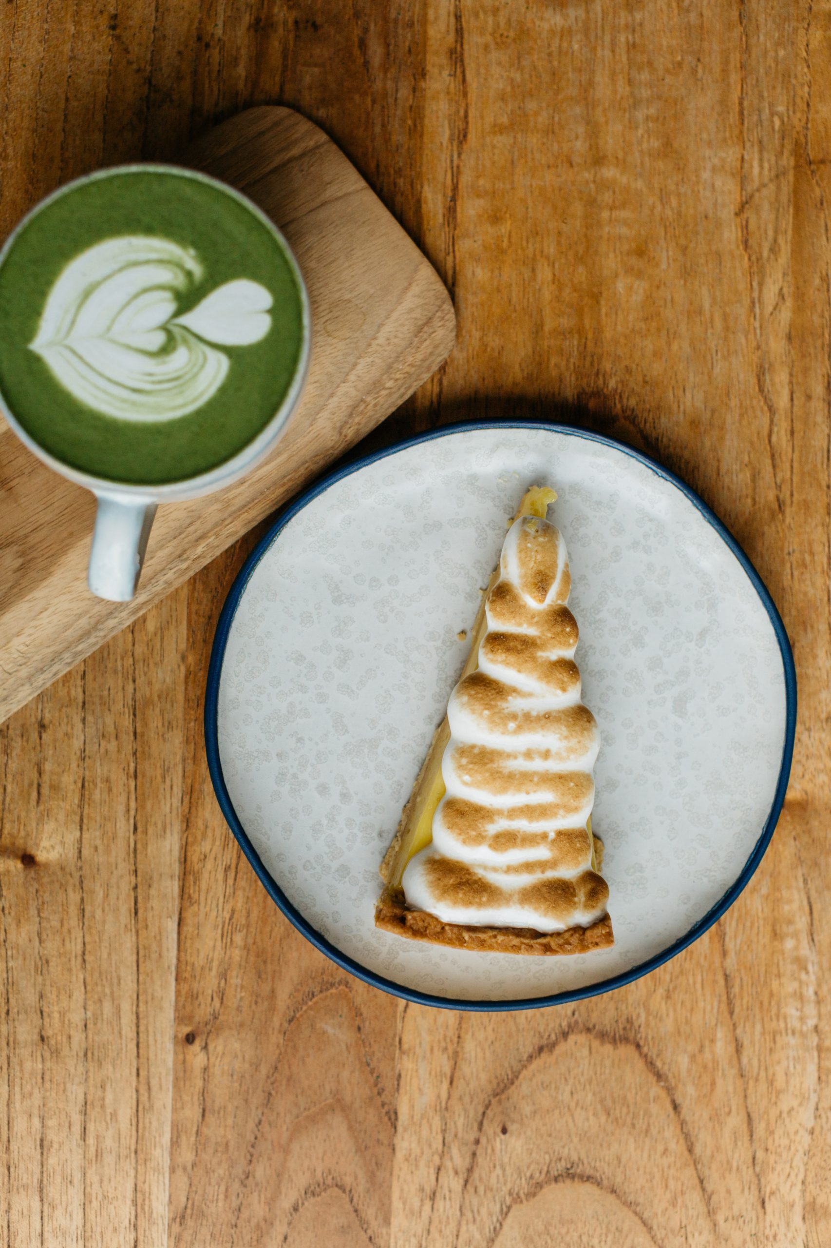A cup of matcha with slice of cake