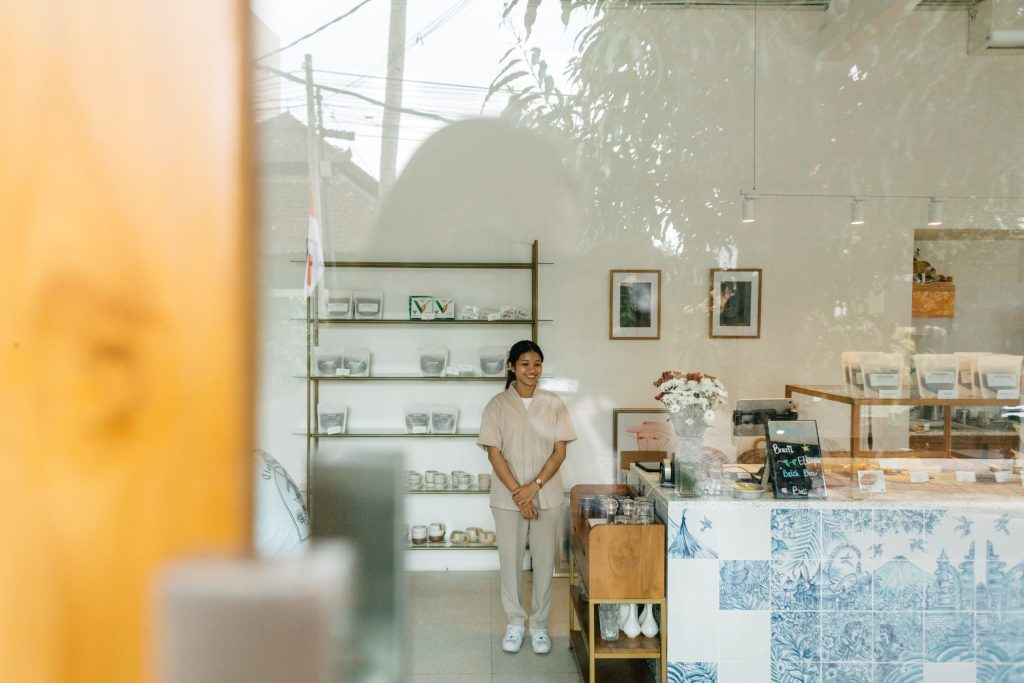 A woman smiling while standing in Ame Bistro & Coffee