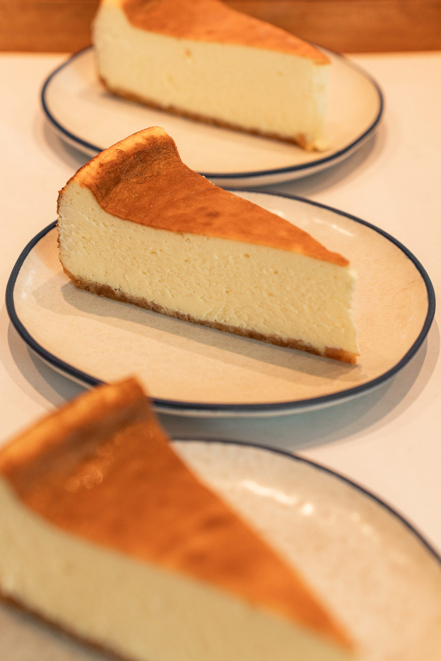 Three plates of cheesecake slice