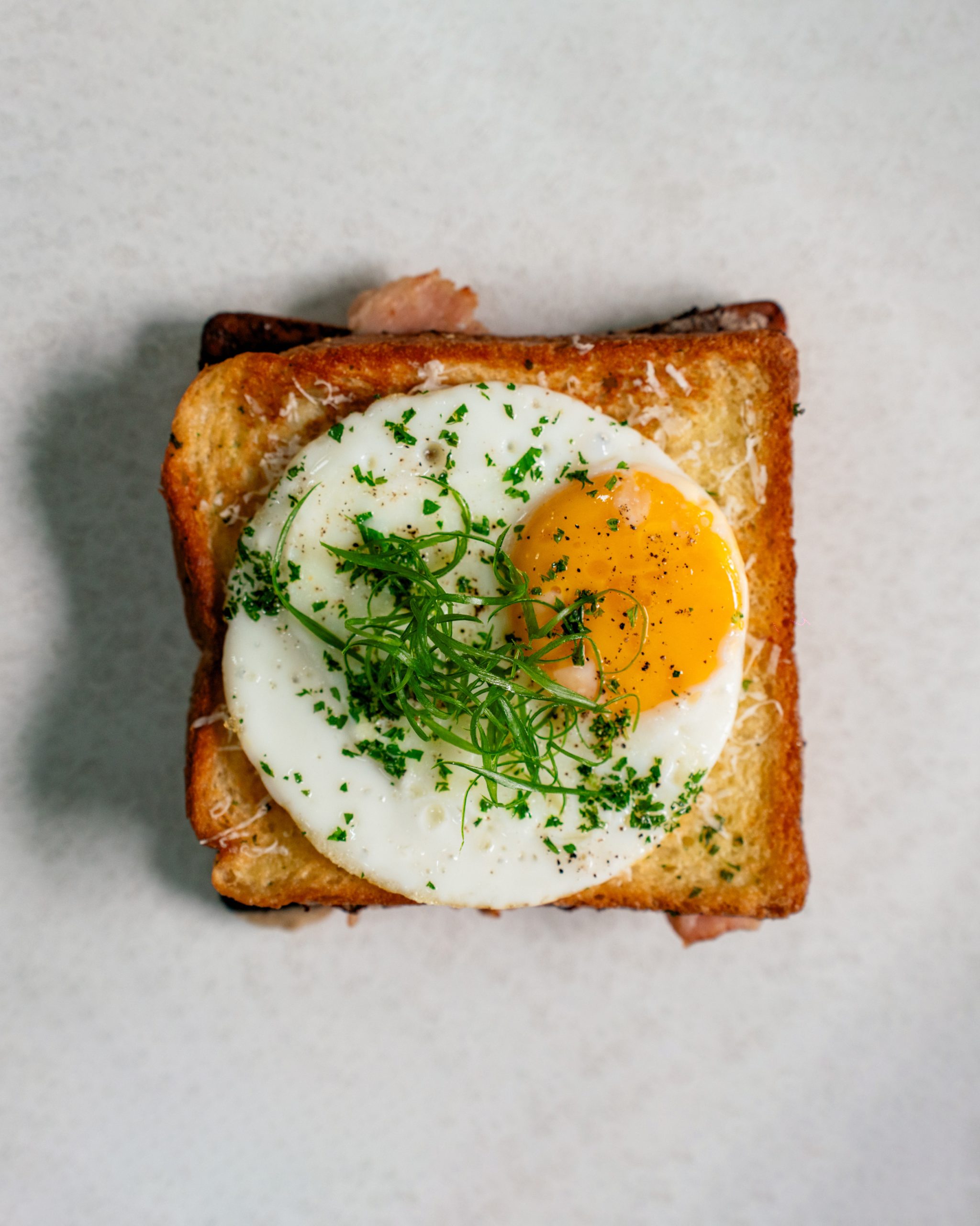 A slice of bread with sunny side up egg