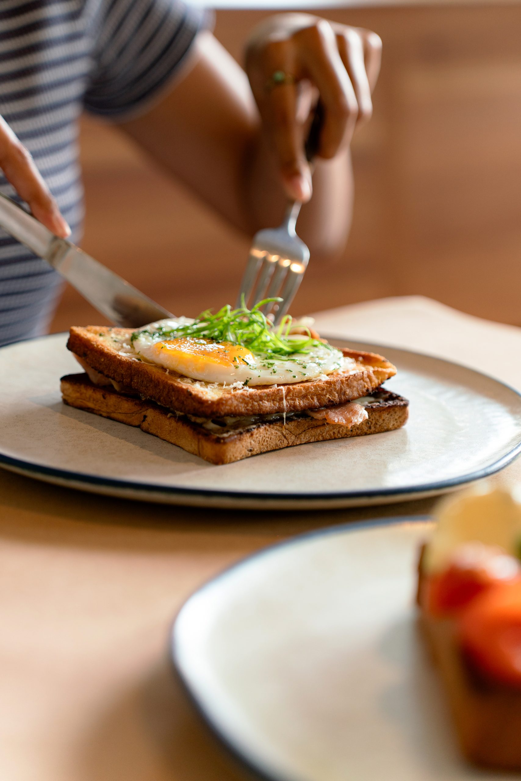 A plate of bread with a sunny side up egg