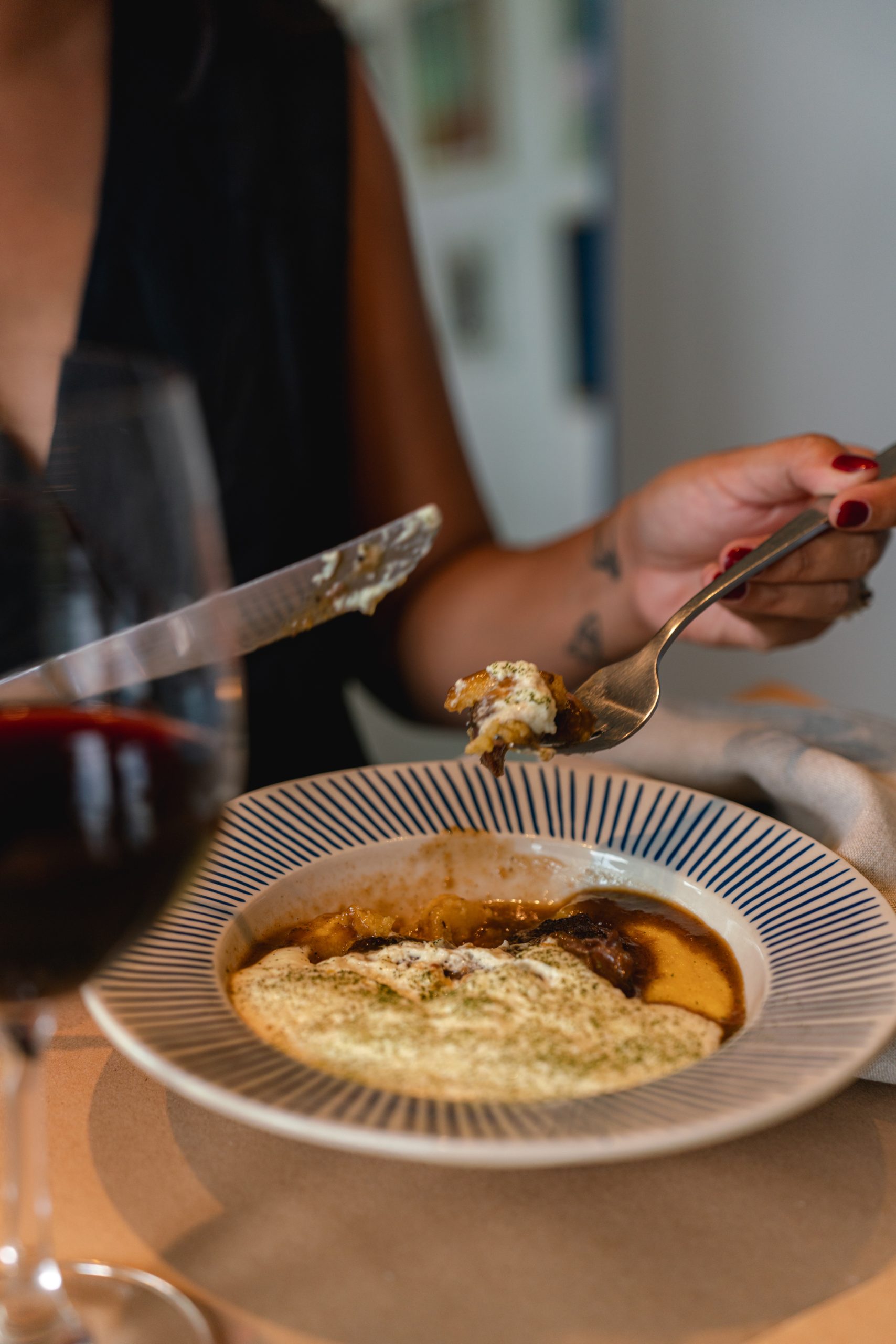 A soup and a glass of wine