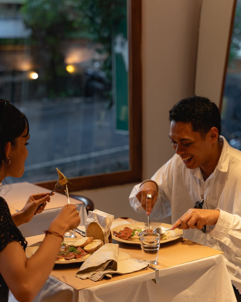 A couple is enjoying dinner at Ame Bistro & Coffee