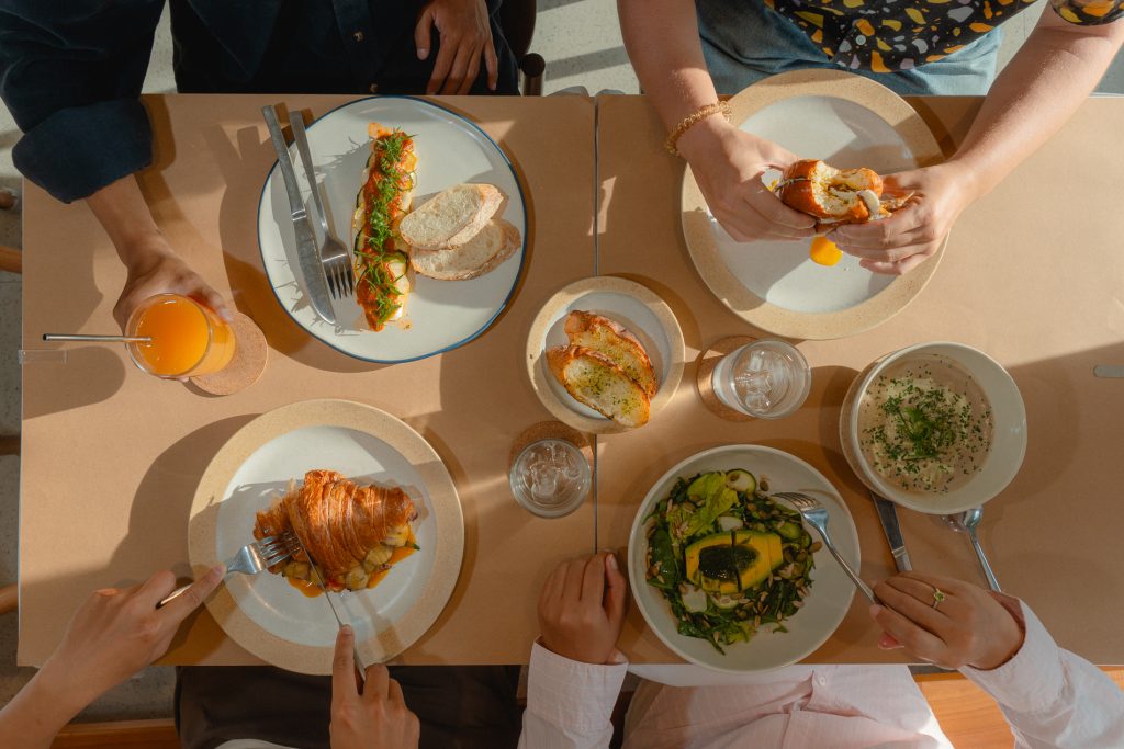 Four people are eating western food
