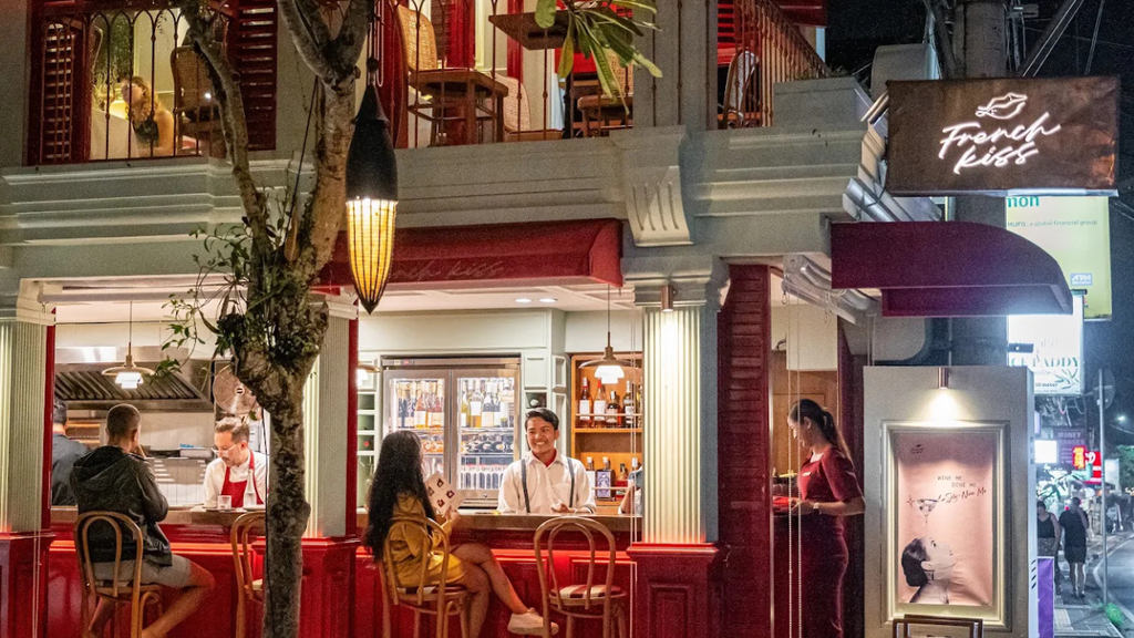 Colorful restaurant entrance with warm lighting and decorative architectural details.