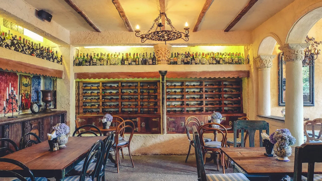 Elegant restaurant interior featuring wooden furniture, decorative lighting, and a spacious dining area.